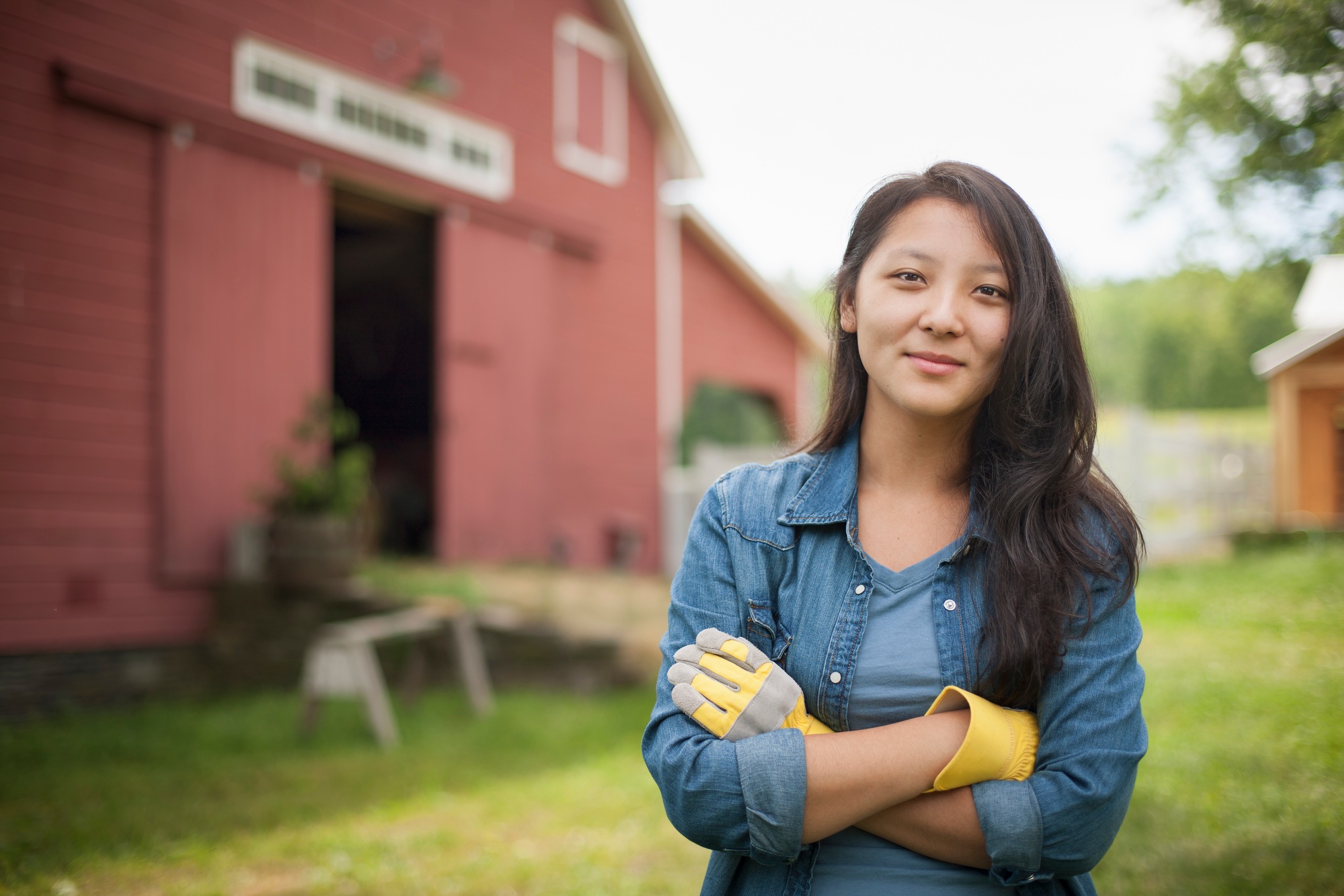 A young woman on a traditional farm in the countryside of New York State, USA